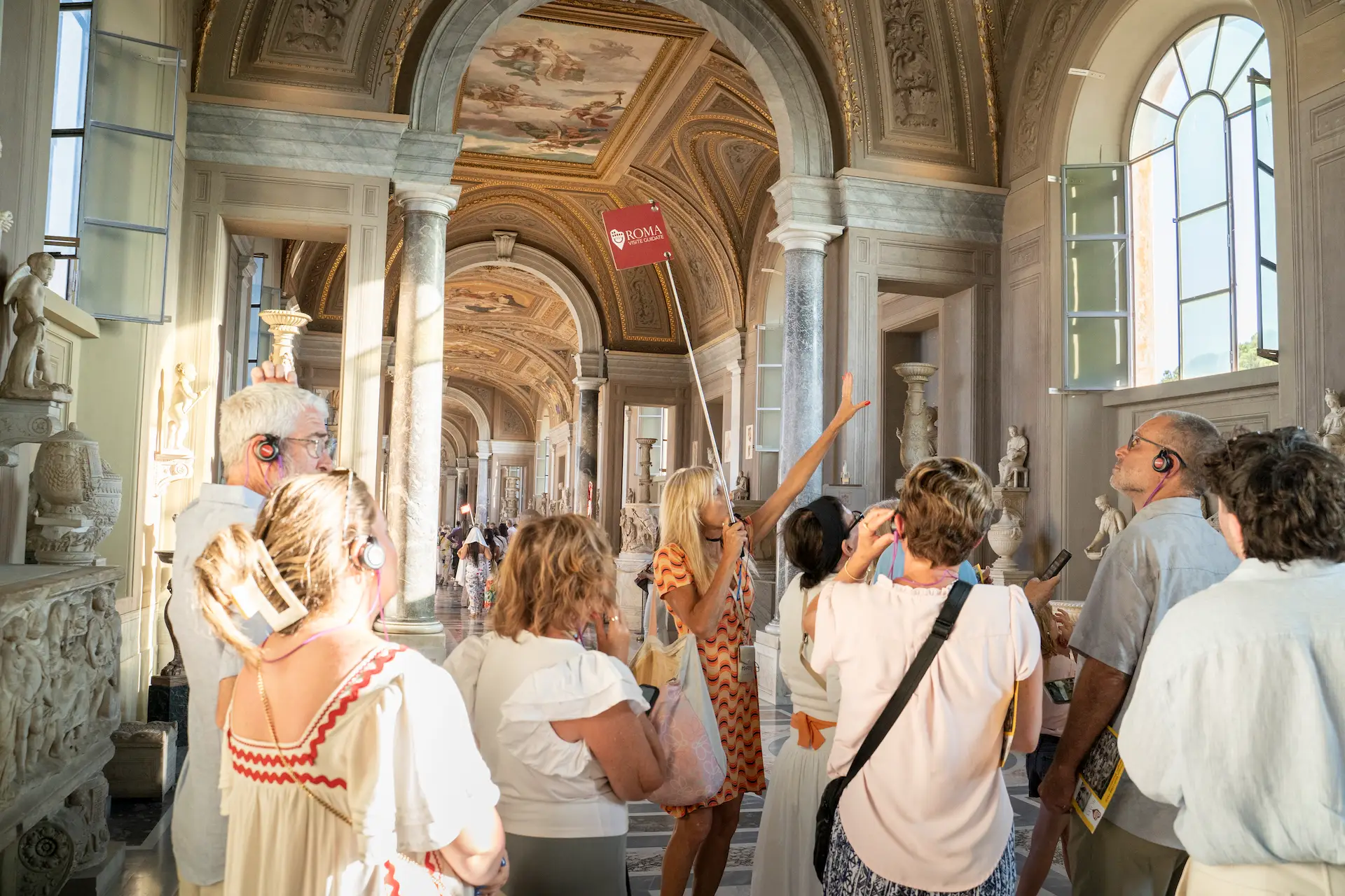 Guided tour group inside the Vatican Museums galleries