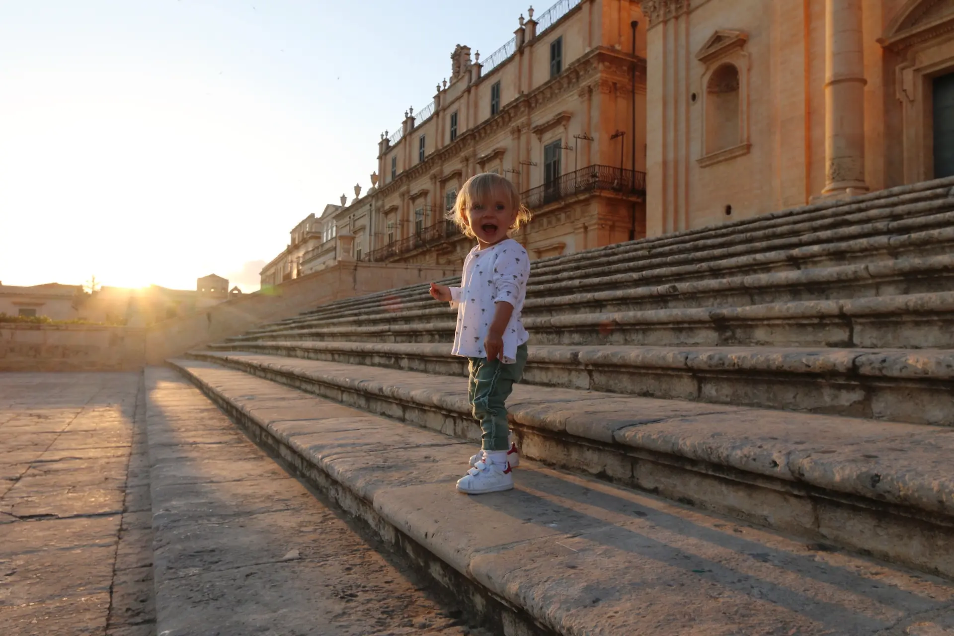 Child exploring historic steps during a family tour in Rome