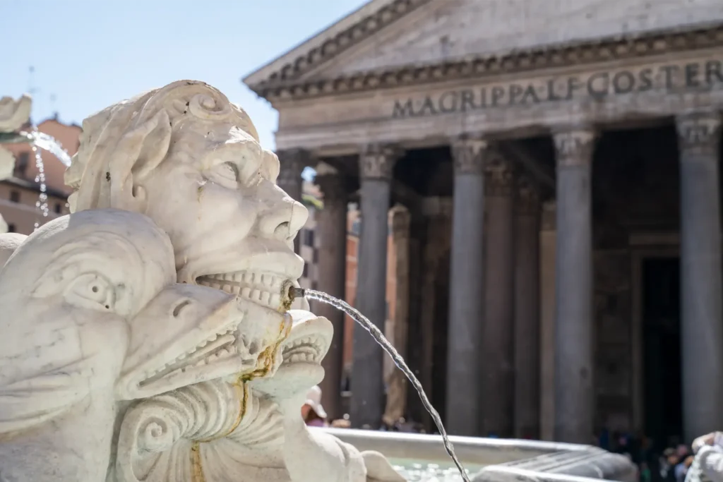 Detail of the Fontana del Pantheon fountain with the Pantheon in the background