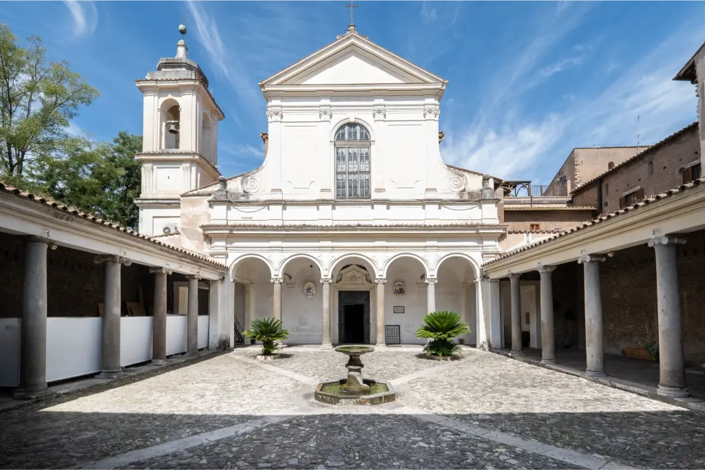 Panoramic view of the Basilica of San Clemente cloister and church facade in Rome