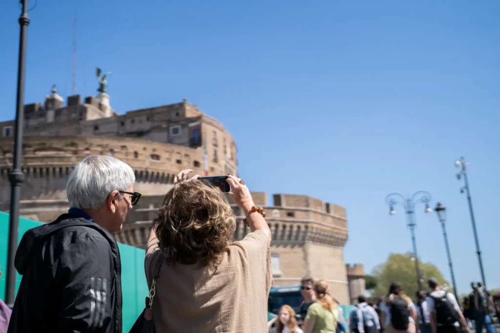 Visitors admiring Castel Sant'Angelo from the riverside